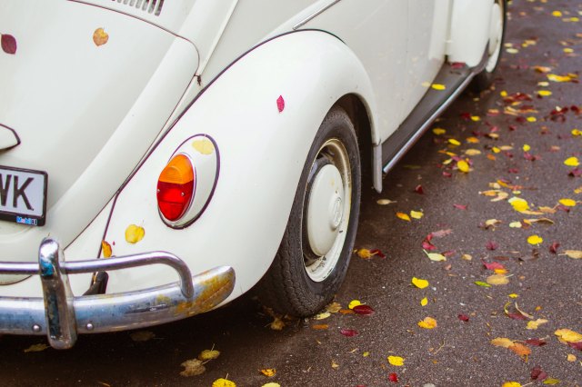 The bumper of a white Volkswagen Beetle