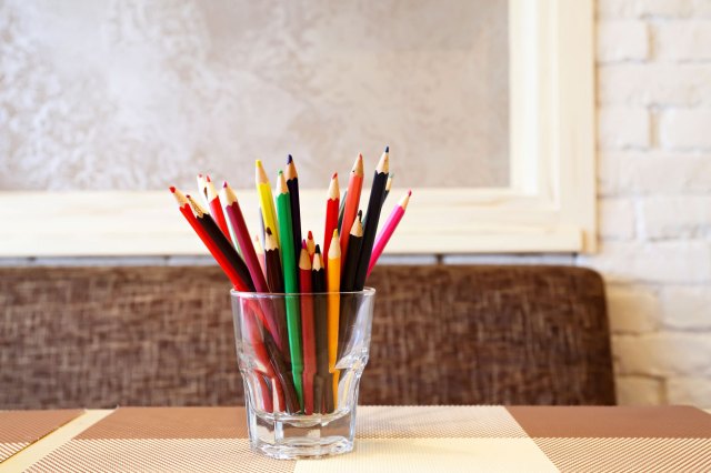 A glass full of colored pencils