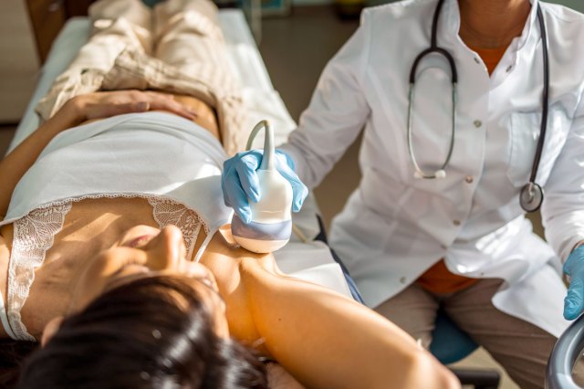 An image of a doctor giving a woman an ultrasound