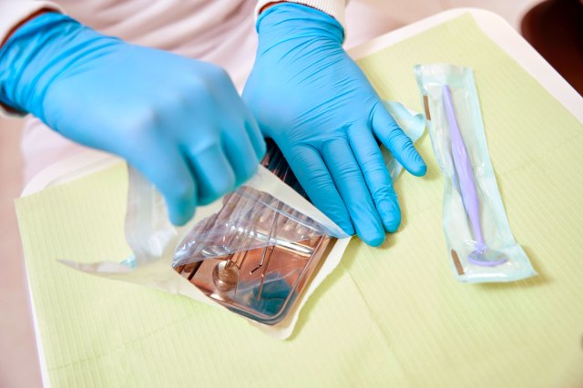 An image of a dentist preparing for examination