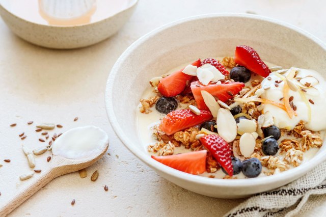 An image of a bowl of yogurt with nuts and berries