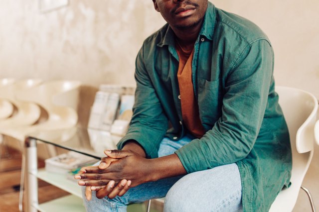 An image of a man sitting in a waiting room