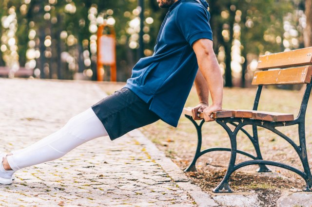 An image of a man doing a tricep dip on a bench