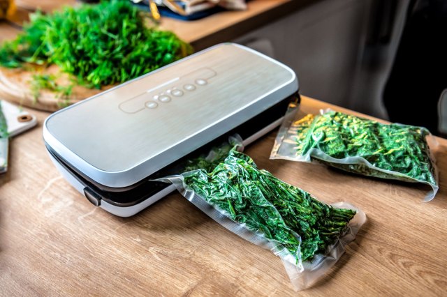 An image of greens being vacuumed sealed