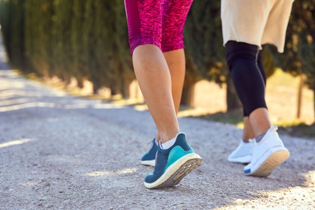 An image of two people walking outside