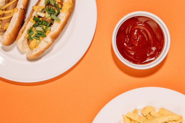 An image of a bowl of ketchen and a plate with a hot dog