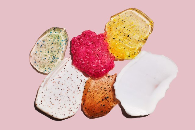 An image of various exfoliants against a pink background