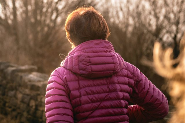 An image of a woman wearing a purple winter jacket