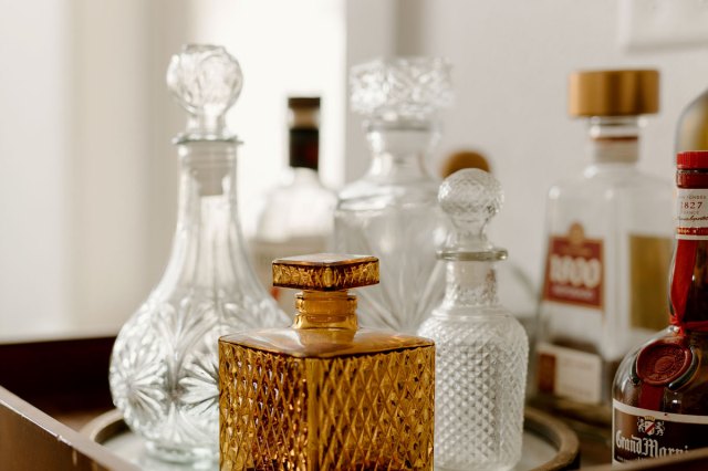 An image of glass bottles on a bar cart