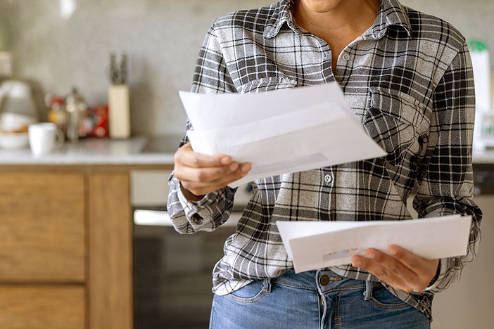 An image of a woman looking at mail