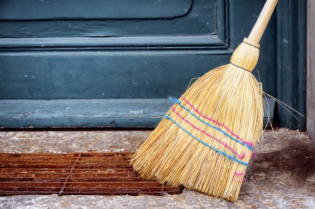 An image of a broom sweeping outside