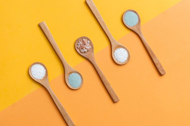 An image of wooden spoons with salt on them