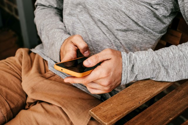 An image of a man holding a mobile phone