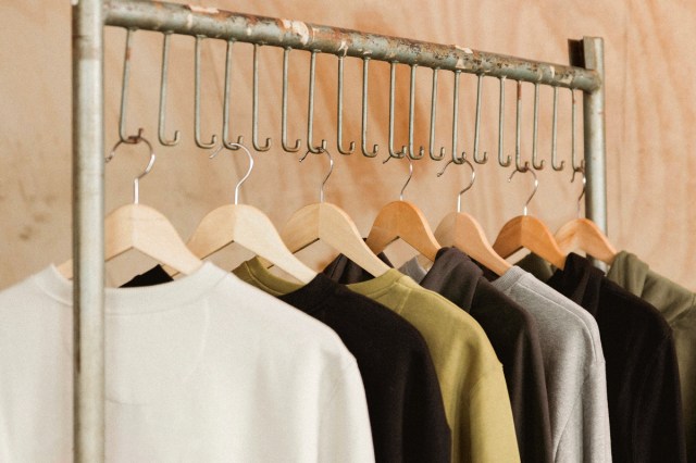 An image of shirts hanging on a clothing rack