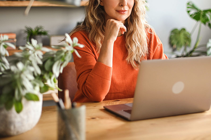 An image of a woman on a laptop