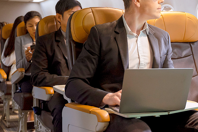 An image of people sitting on an airplane