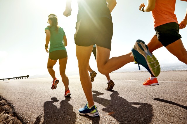 An image of four people running outside