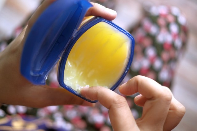 An image of a finger in a jar of petroleum jelly