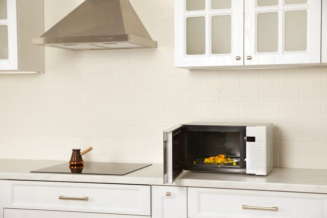 An image of an open microwave on a kitchen counter