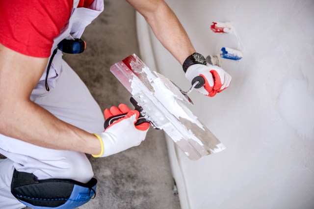 An image of a worker with patching materials