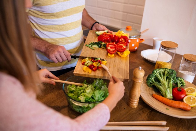 An image of a two people making a salad