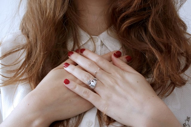 An image of a woman with her hands on her chest