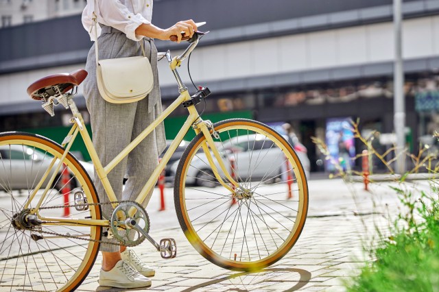 An image of a woman with a bicycle