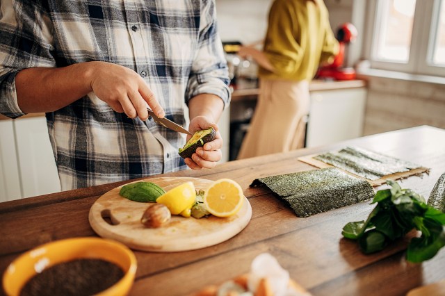 An image of a person cutting vegetables in a kitchen