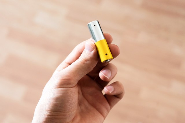 An image of a hand holding a battery