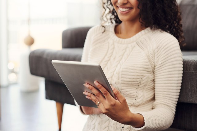 An image of a woman holding a tablet