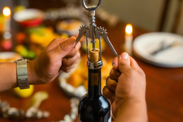 An image of a bottle of wine being uncorked