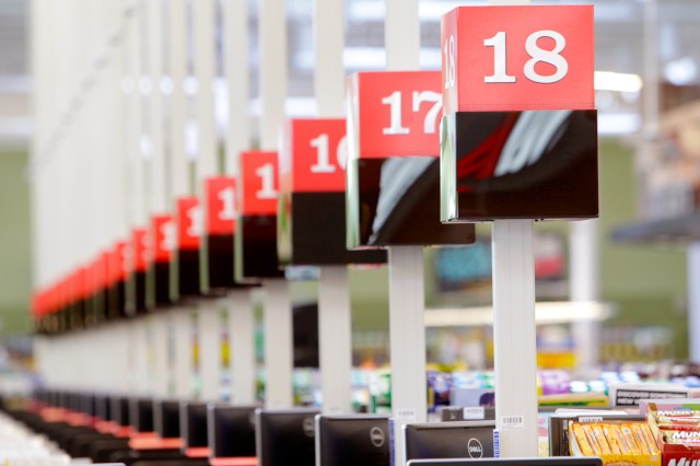 An image of rows of grocery store cash registers