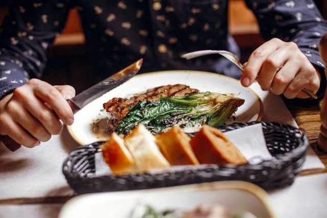 An image of a person eating a steak