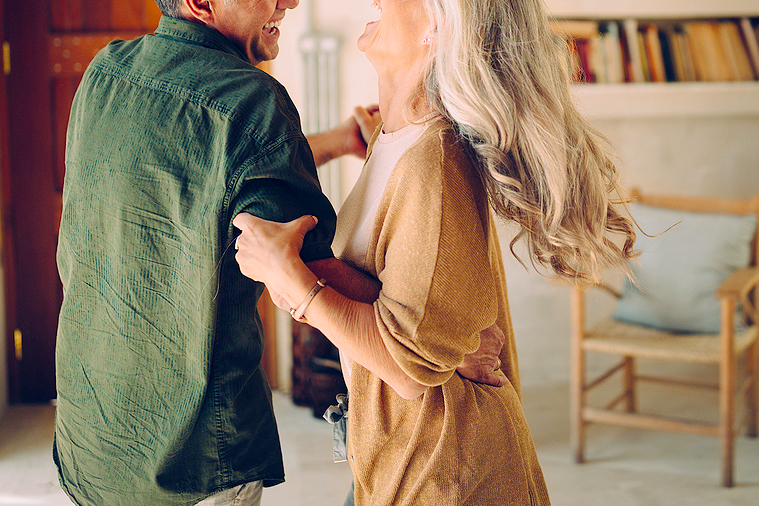 An image of a man and a woman dancing in a living room