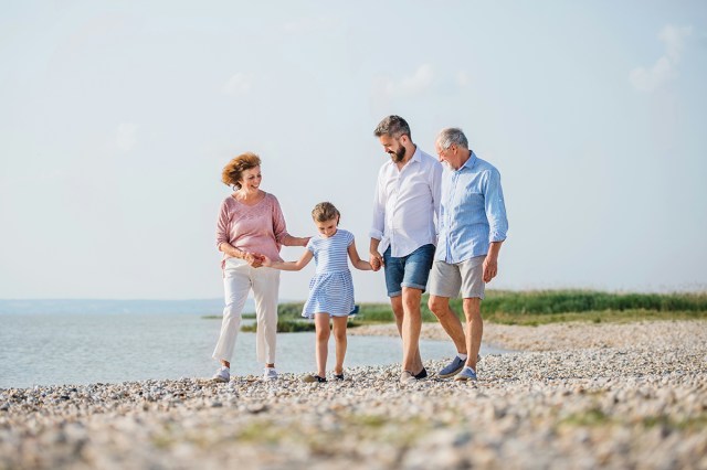 Four people walking on the beach