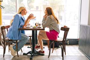 Two women at restaurant table talking