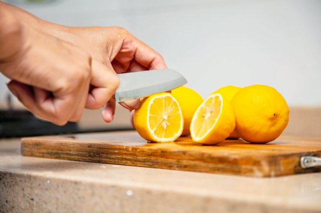 Person slicing lemons with a knife