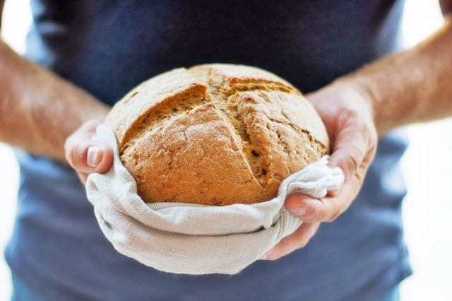 Man holding a loaf of bread