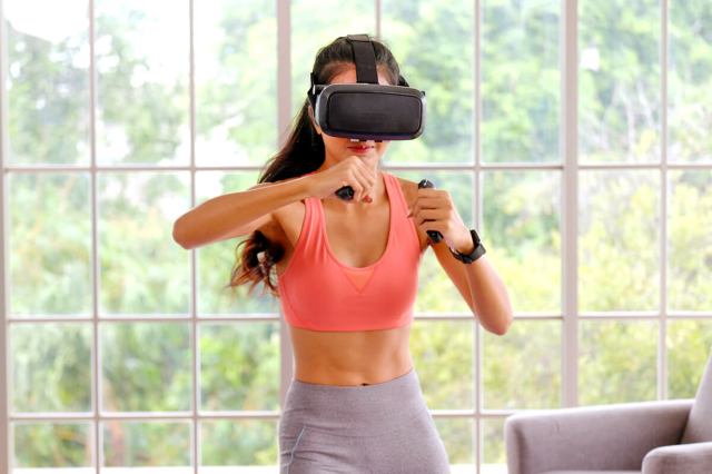 Woman working out while wearing a VR headset