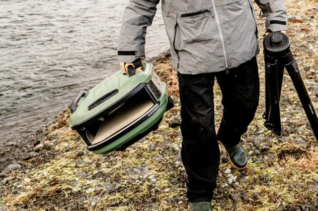 Photo of someone carrying the portable Gozney Tread and stand
